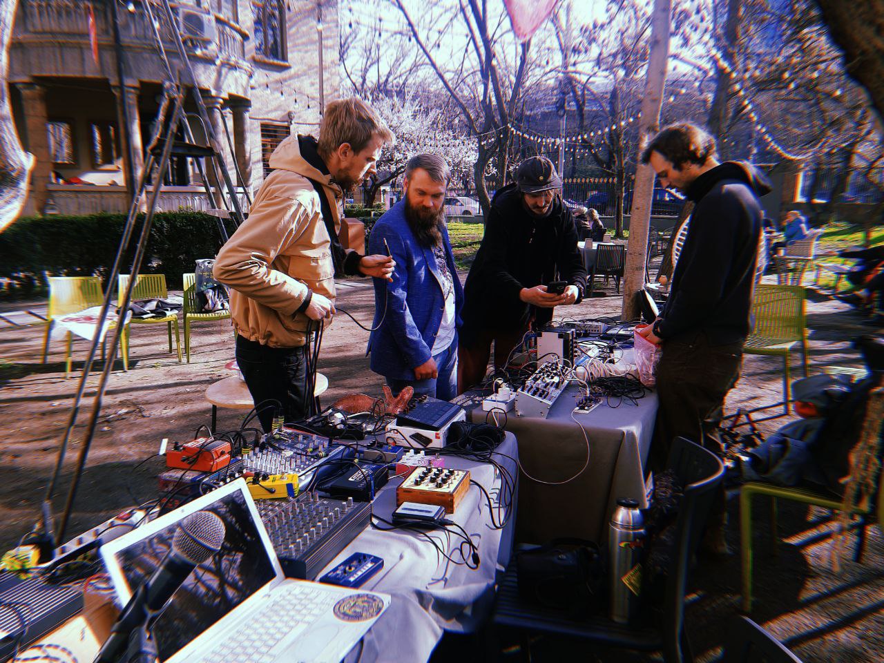 Artists preparing sound equipment outdoors