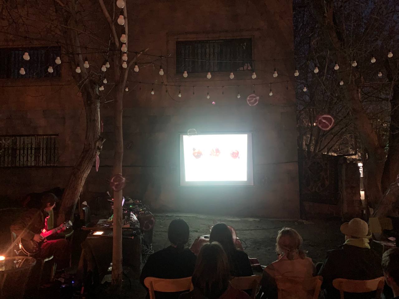 Night outdoor screening with seated audience