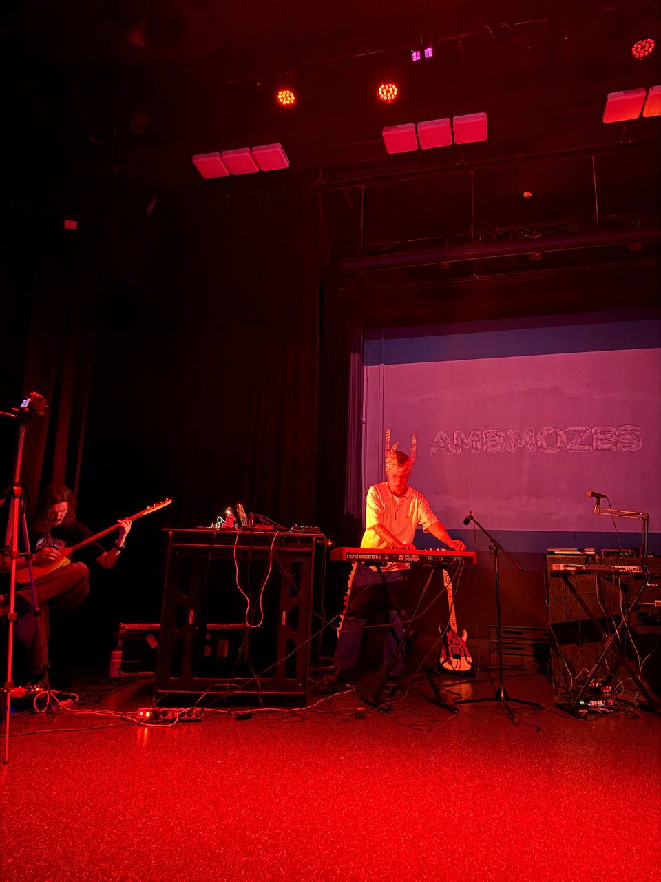 Red-lit live electronic performance on stage